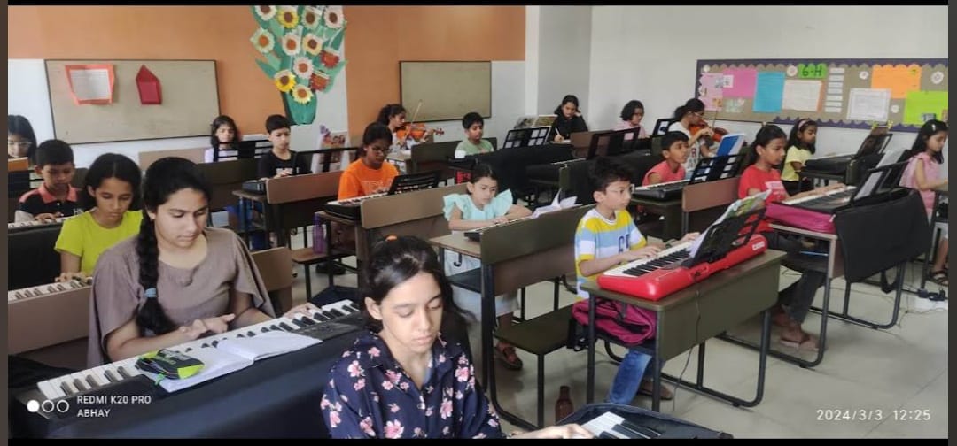Students learning guitar together in class