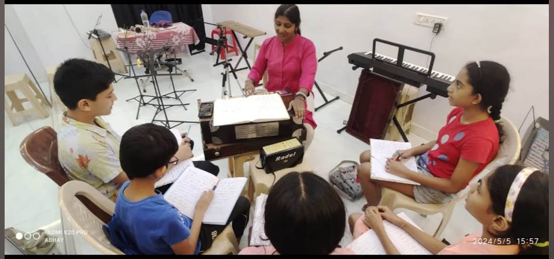 Young students practicing guitar in the academy